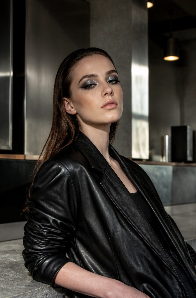 Model with a heavy metal eye look featuring metallic shadows.