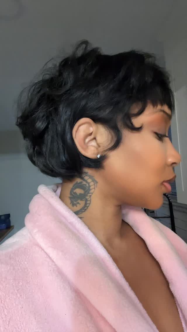 19 Short Pixie Cuts Over 40 With Styling and Color Tips 9 Woman with a black bixie haircut and a dragon tattoo on her neck.