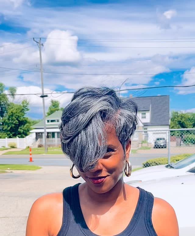 19 Short Pixie Cuts Over 40 With Styling and Color Tips 13 Woman with grey long pixie haircut featuring textured swoops and a deep side part.